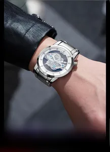 Close-up of skeleton mechanical watch dial with visible gears and silver steel case