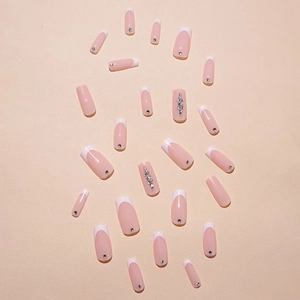 French tip press-on nails in nude pink with square shape and sparkling rhinestone accents