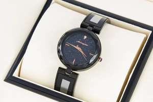 Detail of star dial watch with faceted glass bezel on a beige pillow cushion