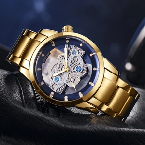 Macro detail of HOURSLY men's gold steel watch with blue bezel and hollow mechanical movement