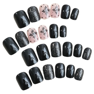 Christmas press-on nails set with black stripes, silver glitter, and pink snowflake patterns