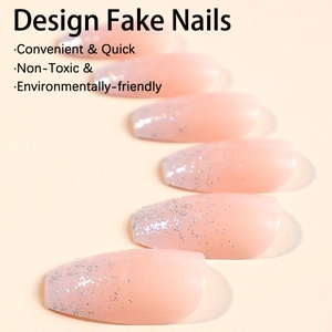 Long coffin ballet nails with nude pink base and silver glitter gradient tips