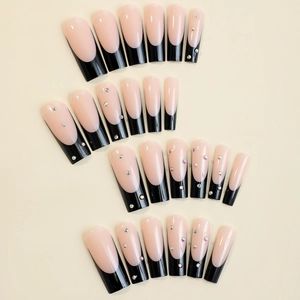 Extra long French tip press-on nails with black tips and colorful rhinestones