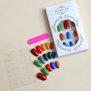 Colorful ballet-style press-on nail kit with pink file, adhesive tabs, and window box