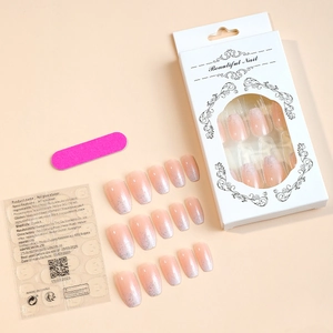 Flat lay of pink glitter ballet press-on nails set with tools in a white window box