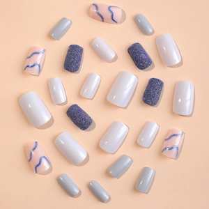 Luxurious press-on nails with milk pattern and blue glitter in a radial arrangement