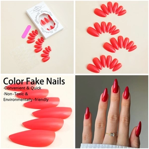 Detail of coral red almond press-on nails set with tools in cream packaging