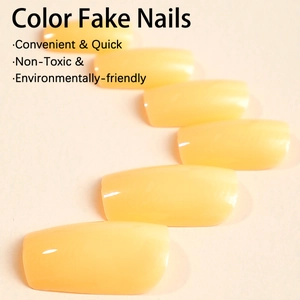 Glossy bright yellow rectangular false nails arranged on a minimalist beige surface
