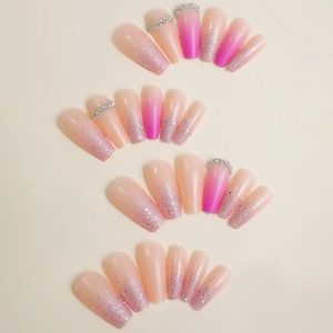 Pink gradient long coffin press-on nails with glitter and rhinestone accents