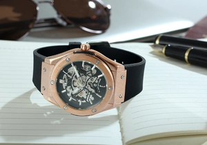 Close-up of skeleton automatic mechanical watch with rose gold case and silicone strap
