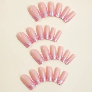 Pink French style press-on nails with long square shape and glitter tips on beige background