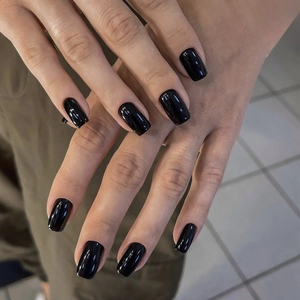 Close-up of glossy black square round press-on nails with mirror shine finish
