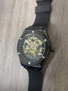 Macro detail of skeleton mechanical watch dial with intricate gold gears and black case