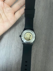 Detailed macro view of the skeleton automatic watch back showing the golden movement