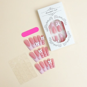 Detailed set of French style press-on nails with 3D bows, pearls and pink bandage art