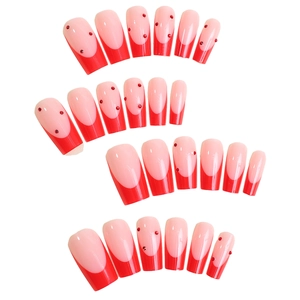French tip press-on nails in red and pink with rhinestones and long trapezoid shape