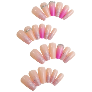 Pink gradient press-on nails with silver glitter and rhinestone accents on white background
