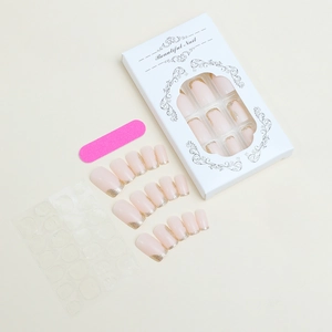 Nude pink press-on nails set with gold glitter French tips and application tools