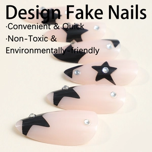 Almond shaped press-on nails in nude pink with black stars and rhinestone accents