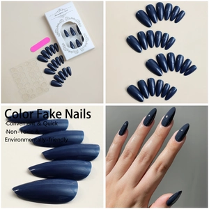 Detail view of almond dark blue press-on nails set with adhesive tabs and nail file