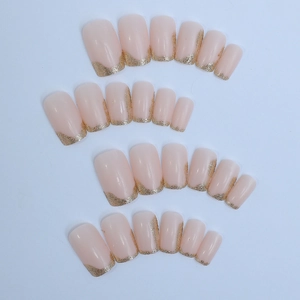 24-piece nude pink press-on nails set with gold glitter french tips in square shape