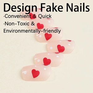 Short square press-on nails in pale pink with red hearts and white polka dot patterns