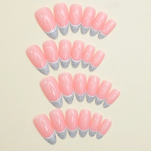 Almond-shaped pink French press-on nails with silver glitter tips in a 24-piece set