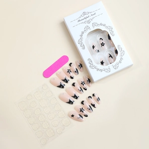 Almond press-on nail kit with pink star design, rhinestones, glue, and nail file