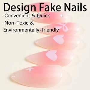 Pink gradient almond press-on nails with white heart and bow designs and starry accents