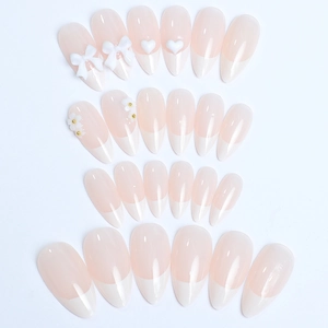 French almond fake nails set with white bows and 3D floral accents on pink base