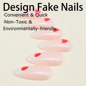 Detail of almond-shaped pink press-on nails featuring a vibrant red heart print design