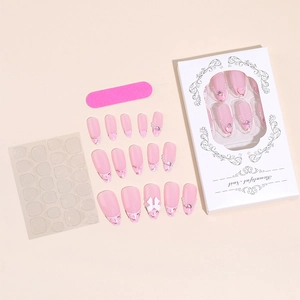 Almond press-on nails set with pink French tips, pearls, bows, and manicure accessories