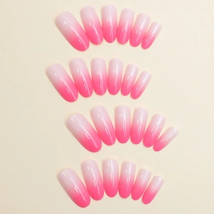Pink gradient press-on nails in long oval shape neatly arranged on a clean background