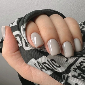 Macro shot of glossy grey square-round press-on nails with mirror-like finish