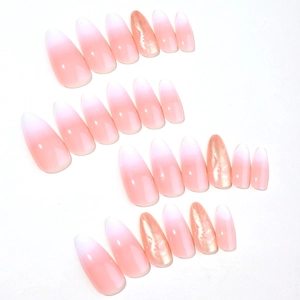 Almond-shaped gradient press-on nails with shimmering gold glitter and marble design