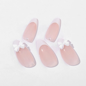 French tip almond press-on nails with white bows and pearls on a nude pink base