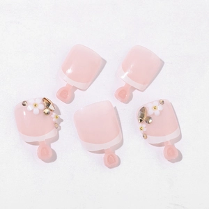 French pink press-on toenails with white floral 3D patterns and sparkling rhinestones