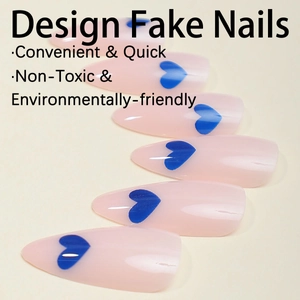 Detailed close-up of almond-shaped nude pink press-on nails with dark blue heart patterns
