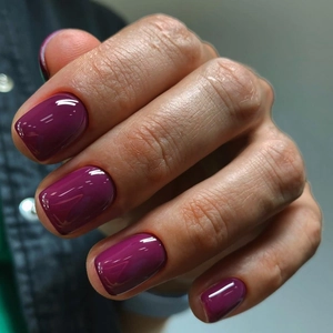 Macro shot of deep purple handmade press-on nails with a glossy mirror finish