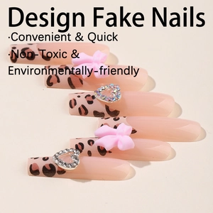 Extra long leopard print press-on nails with pink 3D bows and heart crystal charms