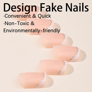 French tip press-on toenails with white edges and gold glitter in natural nude tones