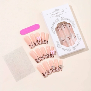 Detailed set of leopard print french tip press-on nails with 3D bows and heart charms