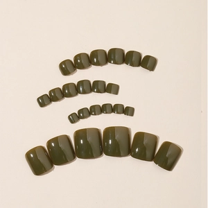 Set of 24 dark olive green glossy press-on toenails in various sizes on beige background