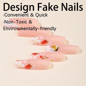 Floral press-on nails with daisy, strawberry, and bee designs on coffin shaped tips