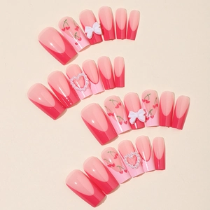 Pink French press-on nails with cherry prints, 3D bows and pearl heart accents