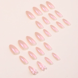 Handmade pearlescent pink press-on nails with 3D bows in a sweet gradient almond shape