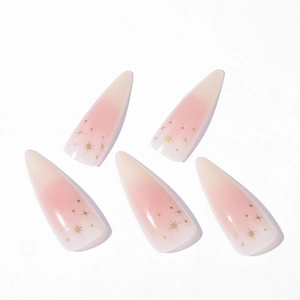 Lange Stiletto Kunstnägel mit rosa-weißem Farbverlauf und goldenen Sternakzenten