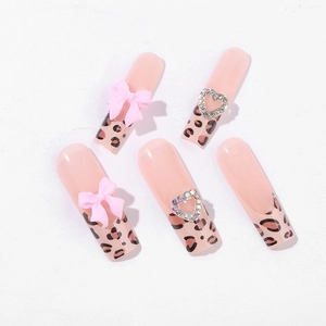 Long coffin leopard print press-on nails with pink bows and heart rhinestone charms