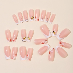 French tip press-on nails with cute bee, strawberry and floral patterns on nude base