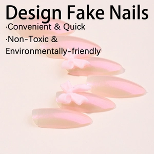Handmade pink gradient press-on nails with 3D bows and pearlescent almond finish